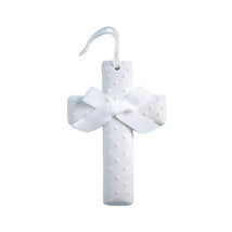 Ceramic white cross with raised dot texture and a white satin bow, designed for decorative purposes.