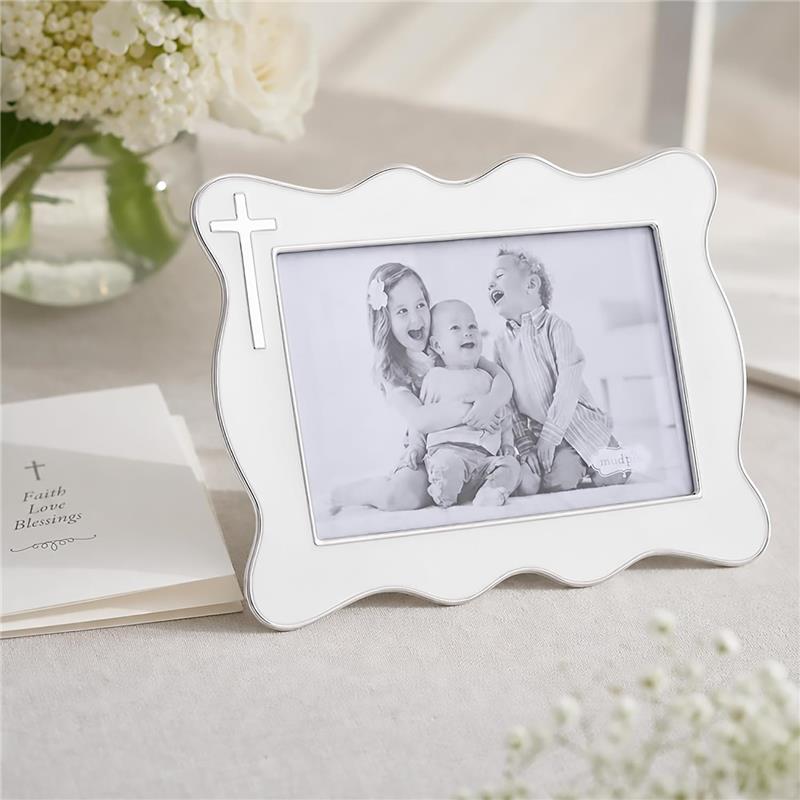 White enamel cross picture frame by Mud Pie, showcasing a black and white photo of three happy children.