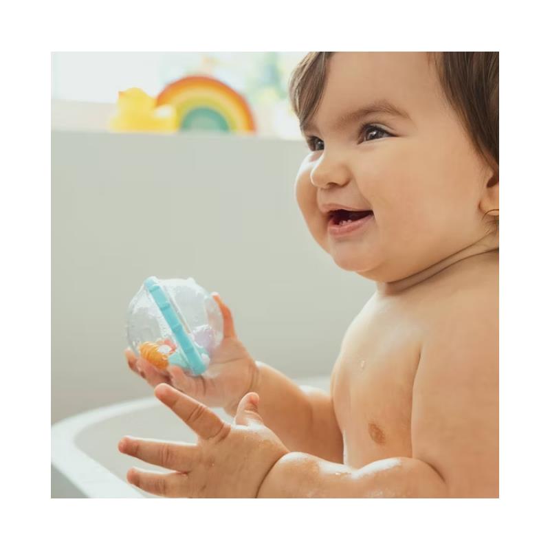 Baby joyfully holding a colorful Munchkin Float & Play bubble toy in a bath setting with water splashes.