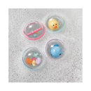Four colorful plastic floatable bubbles in soapy water, featuring toy shapes like a duck, fish, and seashells.