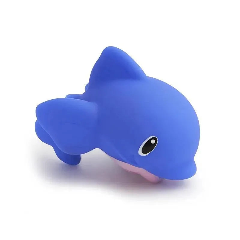 Blue dolphin-shaped bath squirter toy with a smiling face, part of the Munchkin Bath Lake Squirters 8-pack.