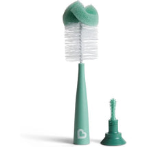 Bristle bottle brush with a modern design in teal, featuring a soft sponge top and an additional small cleaning brush.