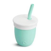 Munchkin C’est Silicone! training cup in mint green, featuring a white lid and straw for easy drinking.