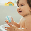 Smiling baby holding a Munchkin Float and Play Bubble toy, with a colorful rainbow in the background.