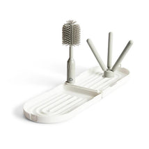 Munchkin Portable Drying Rack with a collapsible stand and a bottle brush for drying baby items.