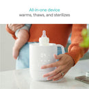 Munchkin Precision Baby Bottle Warmer in white, warming a bottle, with visible screen displaying settings.