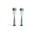 Two Munchkin sponge bottle brushes with soft, curved heads in gray and teal, designed for effectively cleaning bottles.