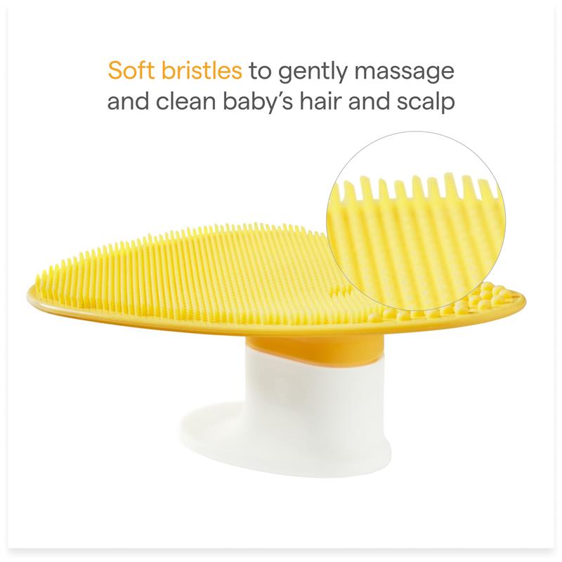 Silicone baby bath brush with soft yellow bristles for gentle hair and scalp cleaning, featuring a soap dispenser.