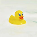 Munchkin White Hot Safety Bath Ducky, a bright yellow rubber duck with friendly eyes and an orange beak, floating in soapy water.