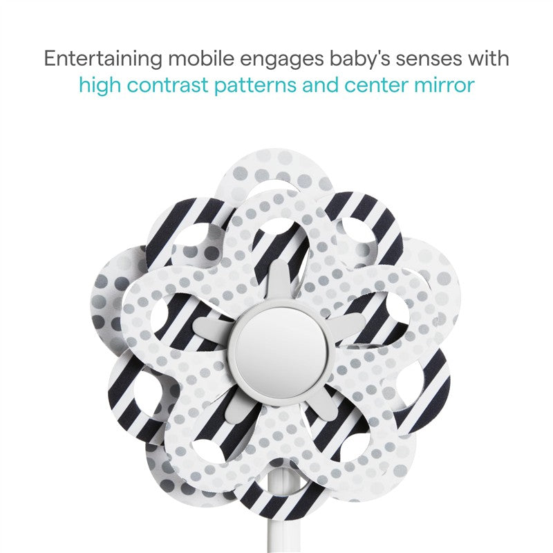 High-contrast infant mobile featuring a flower design with polka dots and stripes, centered around a mirror to engage baby’s senses.