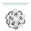 High-contrast infant mobile featuring a flower design with polka dots and stripes, centered around a mirror to engage baby’s senses.