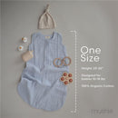 100% organic cotton baby wearable blanket in Tradewinds color, accompanied by a beige hat and teething toys, with sizing details.
