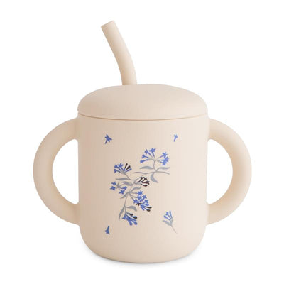 Silicone toddler training cup in lilac flowers design with dual handles and a straw.