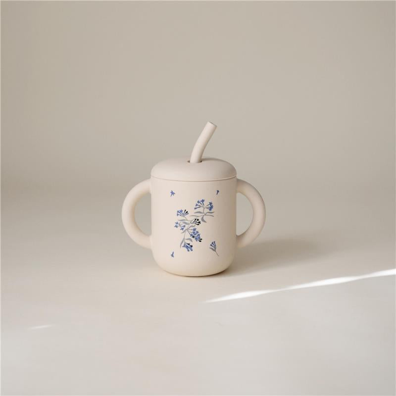 100% silicone training cup in lilac with floral design, featuring a straw and two easy-grip handles.