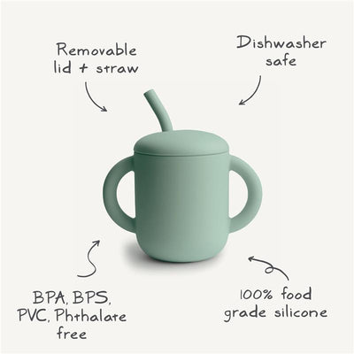 Mushie silicone training cup with removable lid and straw, featuring green color and notes on safety and care.