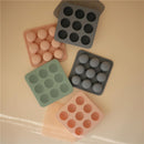 Mushie Baby Food Freezer Trays in blush and other colors, featuring round compartments for freezing baby food servings.