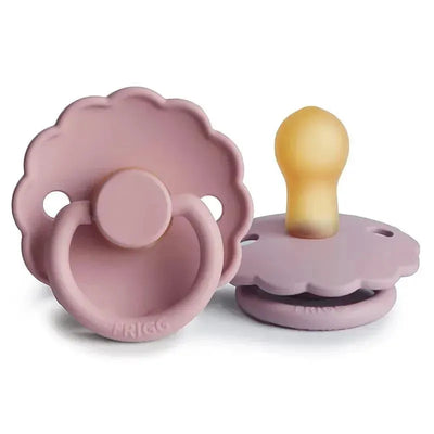 Natural rubber baby pacifiers in baby pink and soft lilac, designed for infants 0-6 months, featuring a daisy-shaped shield.