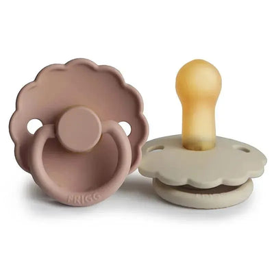 Natural rubber pacifiers in blush and cream colors, designed for babies aged 0 to 6 months, featuring a daisy shape.