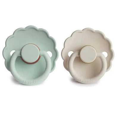 Two Frigg Daisy natural rubber baby pacifiers in seafoam green and cream, designed for ages 6-18 months.