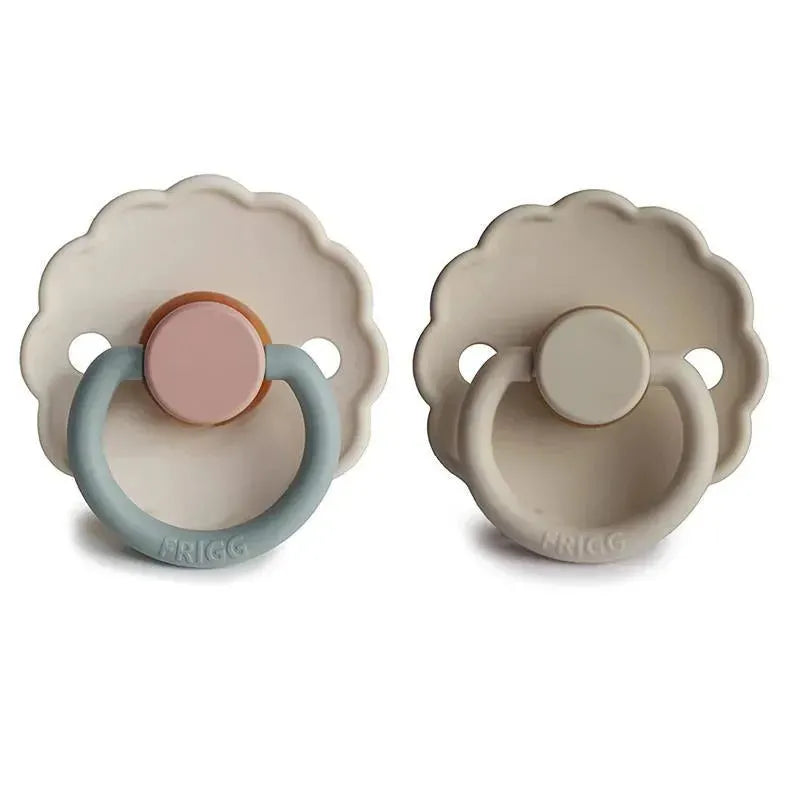 Two Frigg Daisy natural rubber pacifiers in sandstone and cotton candy colors, suitable for infants 0-6 months.