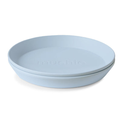 Mushie Silicone Round Plate Dinnerware Set in Powder Blue, featuring two stackable plates with a smooth finish.