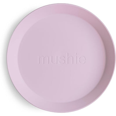 Soft lilac silicone round plate from Mushie, featuring a smooth surface and an embossed brand name.