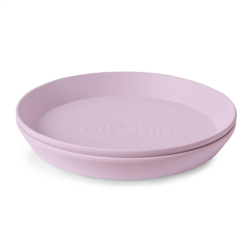 Mushie Silicone Round Plate Dinnerware Set in Soft Lilac, featuring two stackable plates with embossed logo.