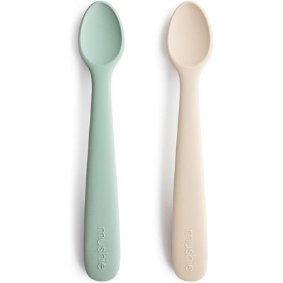 Mushie Silicone Feeding Spoons 2 Pack in Cambridge Blue and Shifting Sand, designed for baby feeding.