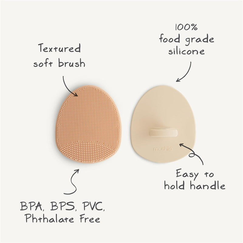 Silicone baby bath cradle cap brushes in Tradewinds and Periwinkle colors, featuring textured soft bristles and easy-to-hold handles.