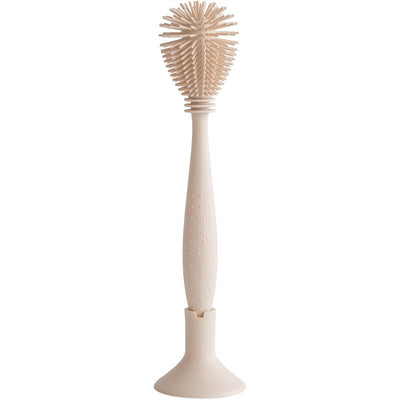 Mushie Silicone Baby Bottle Brush in Shifting Sand color, featuring a soft bristle head and ergonomic handle.