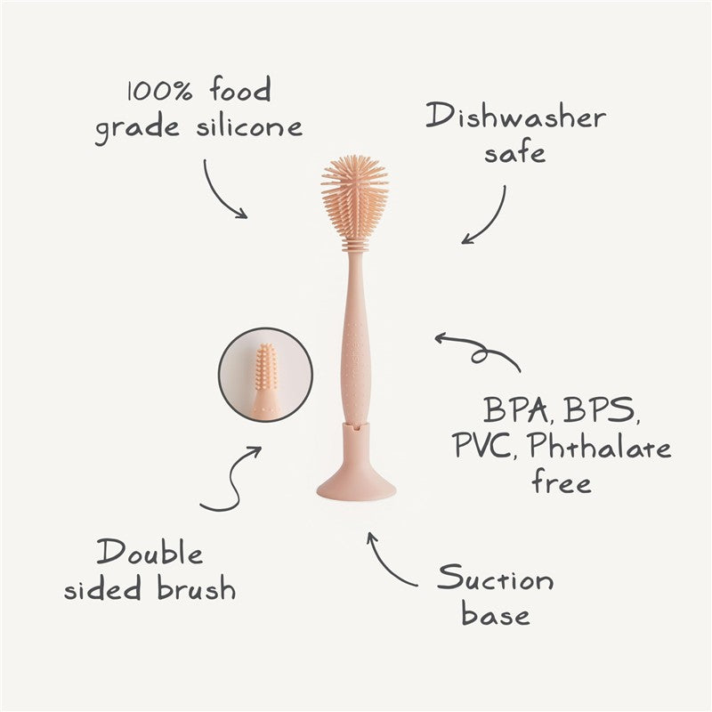 Mushie Silicone Baby Bottle Brush in Shifting Sand, featuring double-sided bristles, suction base, and dishwasher safe design.