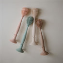 Silicone baby bottle brushes in pastel colors: peach, green, white, and beige, designed for safe cleaning.