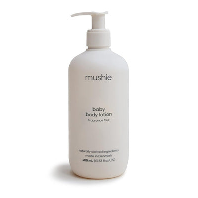 Mushie baby body lotion in a white pump bottle, 13.53 fl oz, fragrance-free, made from naturally derived ingredients.