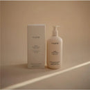 Mushie Baby Organic Body Lotion, 13.53 fl oz, fragrance-free, displayed alongside its packaging on a neutral background.