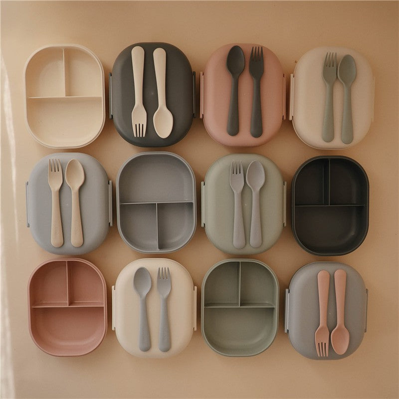 Mushie Bento Lunch Boxes in various colors displayed, each with matching utensils, showcasing their compartmentalized design.