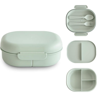 Mushie Bento Lunch Box in sage green, featuring a compartmentalized design with included utensils.