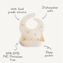 Mushie Silicone Baby Bib in ivory with colorful star designs, made from food grade silicone, dishwasher safe, and features a deep pocket.