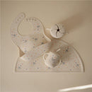 Silicone baby bib with a playful design and a matching cup, both featuring Bluey characters and colorful stars.
