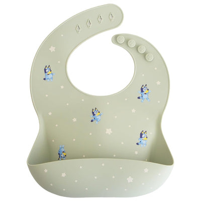 Mushie Silicone Baby Bib in Bluey Sage with blue character illustrations and a pocket for catching food.