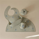 Silicone baby bib, bowl, and cup in Bluey Sage color, featuring playful Bluey character designs on a placemat.