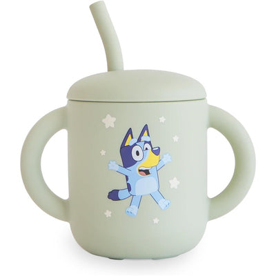 Mushie Silicone Training Cup in sage green with a fun character print and a removable straw, designed for toddlers.
