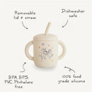 Silicone training cup in sage, features removable lid and straw, dishwasher safe, BPA-free, depicted with playful characters.