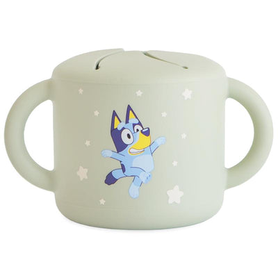 Mushie Bluey X Mushie snack cup in sage green featuring a smiling Bluey character and star designs.