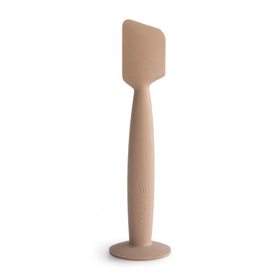 Mushie silicone diaper cream applicator in a neutral tone, designed for easy and hygienic application of diaper cream.