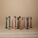 Mushie Silicone Diaper Cream Applicators in various colors, arranged neatly on a neutral background.
