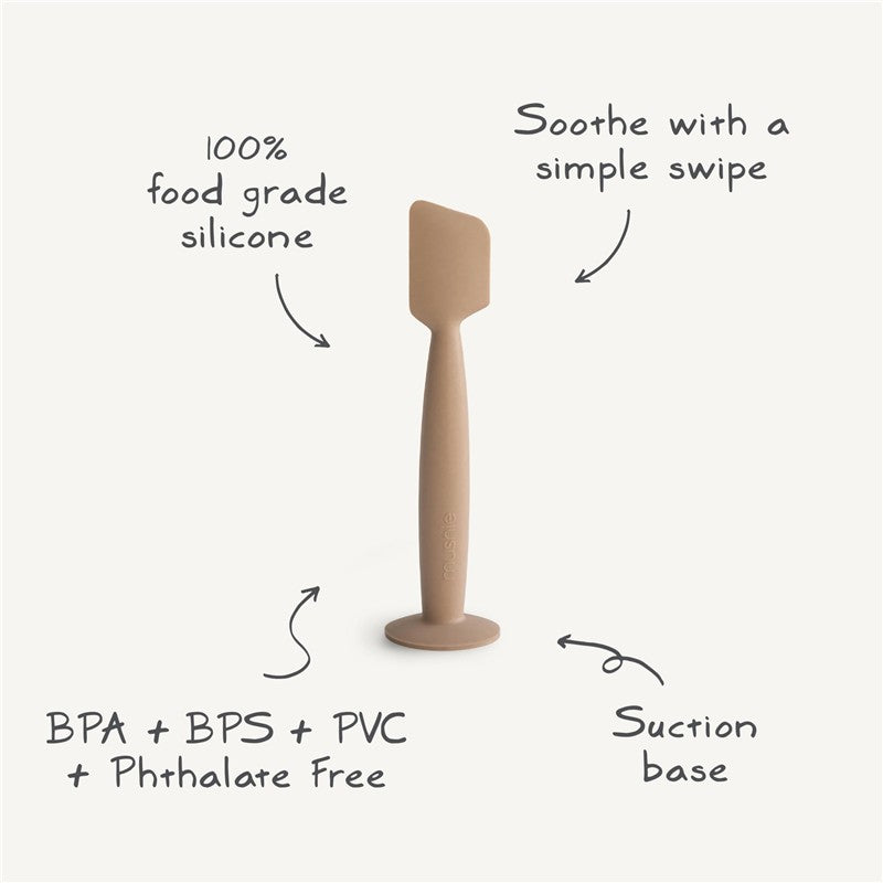 Mushie Silicone Diaper Cream Applicator in natural tone, made of 100% food-grade silicone, features a suction base.