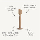 Mushie Silicone Diaper Cream Applicator in natural tone, made of 100% food-grade silicone, features a suction base.