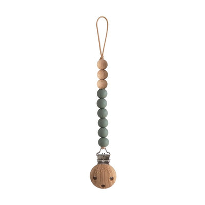 Mushie Eva pacifier clip in dried thyme color, featuring wooden beads and a metal clip.