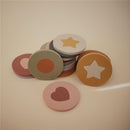 Colorful foam bath puzzle pieces in various shapes, including circles with star, heart, and dot designs.