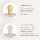 Natural rubber baby pacifier with a blush/cream design, featuring a rubber nipple and a silicone nipple, both BPA-free.